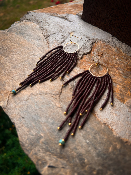 Brown beaded earrings with brass pendant